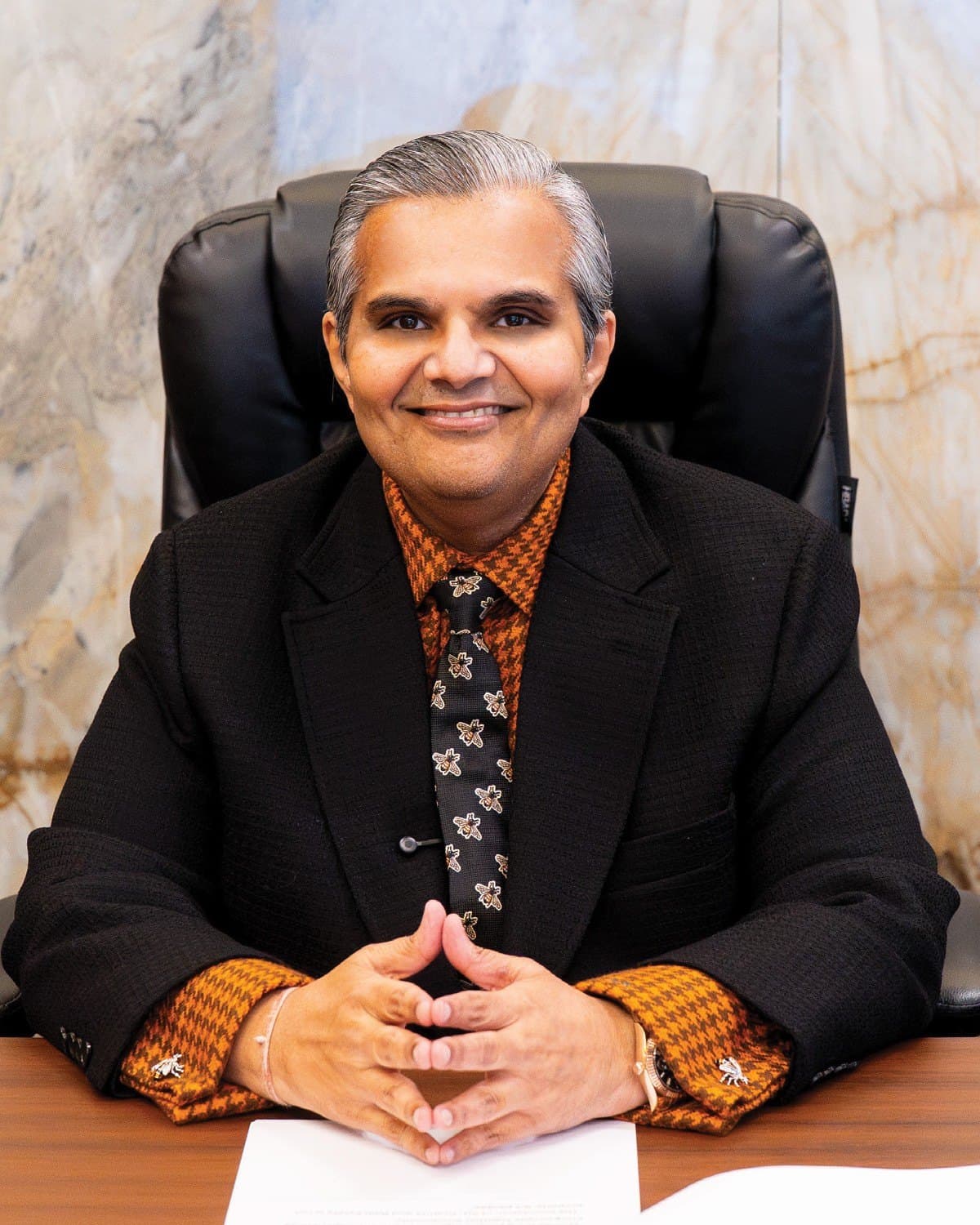 Kalpesh Kinariwala at his desk, smiling