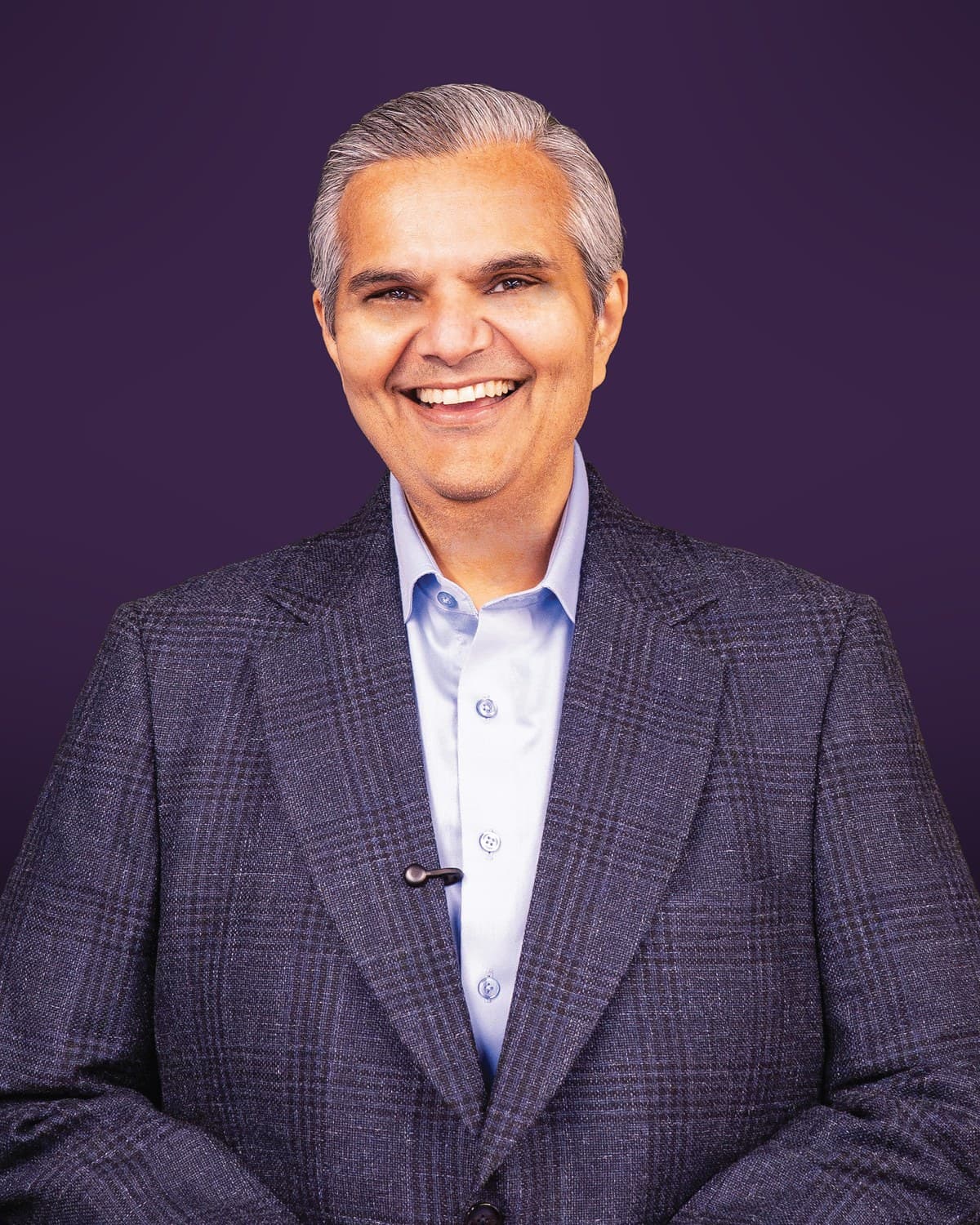 Kalpesh Kinariwala, smiling, in a checked jacket