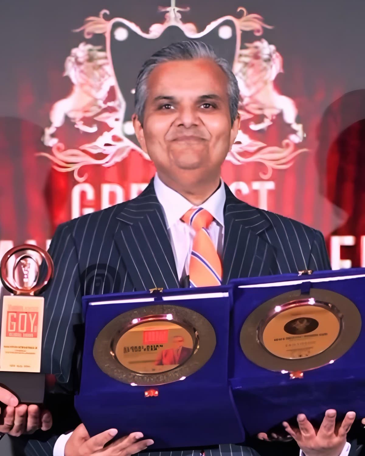 Kalpesh Kinariwala holding the AsiaOne Global Asian of the Year plaque and trophy